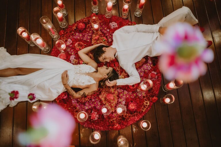 costa rica A romantic photo of a bride and groom embracing on a bed of roses and candles, captured by an exceptional Costa Rica photographer specializing in playa weddings.