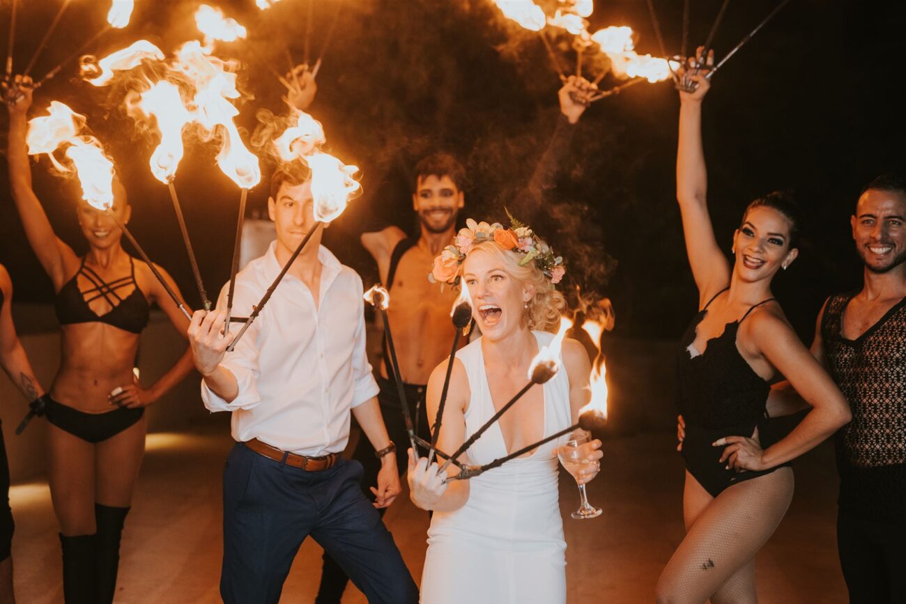 costa rica A group of people holding torches and burning at a playa wedding, captured in a stunning photo.