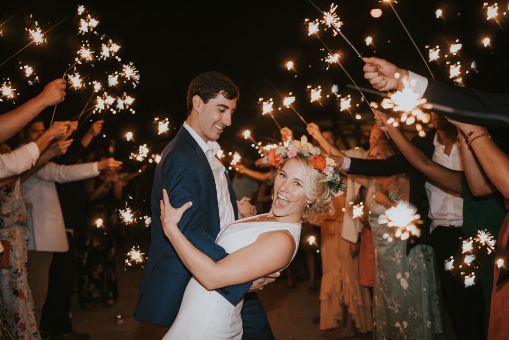 costa rica A man and woman dancing with sparklers on a playa beach in Costa Rica, captured by a talented wedding photographer.