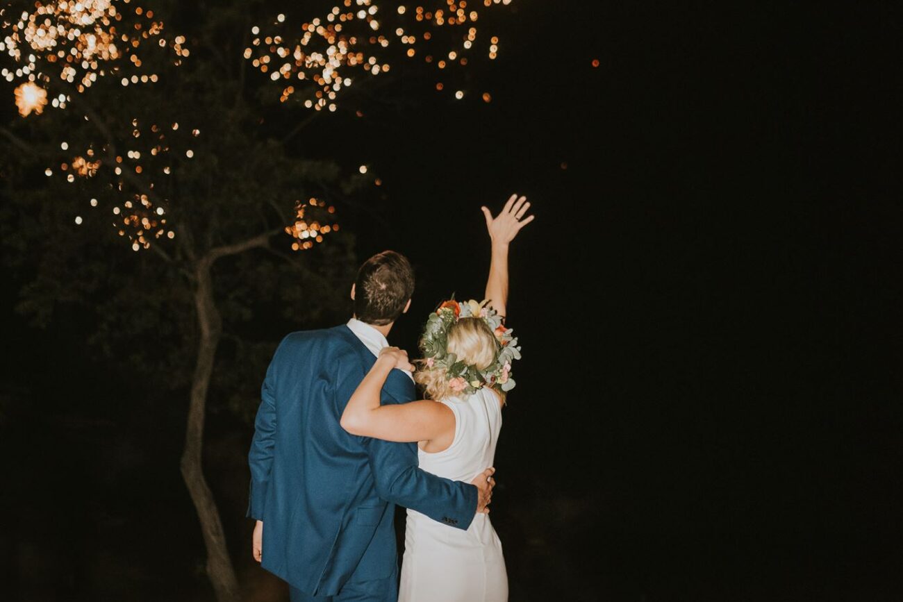 costa rica A bride and groom having their wedding photo taken on the beach in Costa Rica, with sparklers lighting up the sky.