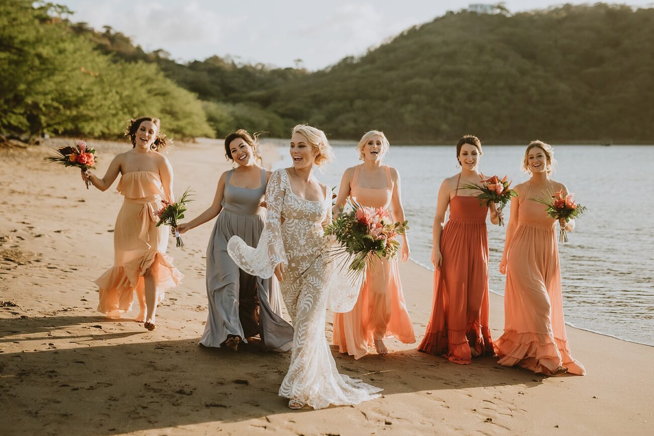 costa rica A bride and her bridesmaids pose for a photo along the beach in Costa Rica.