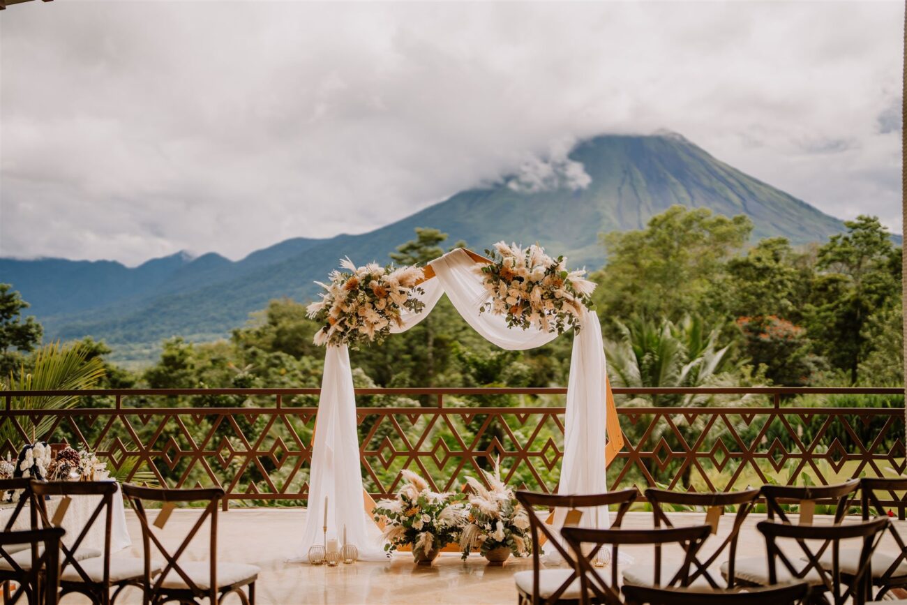 costa rica An outdoor wedding ceremony with a mountain in the background captured by a Costa Rica photographer.