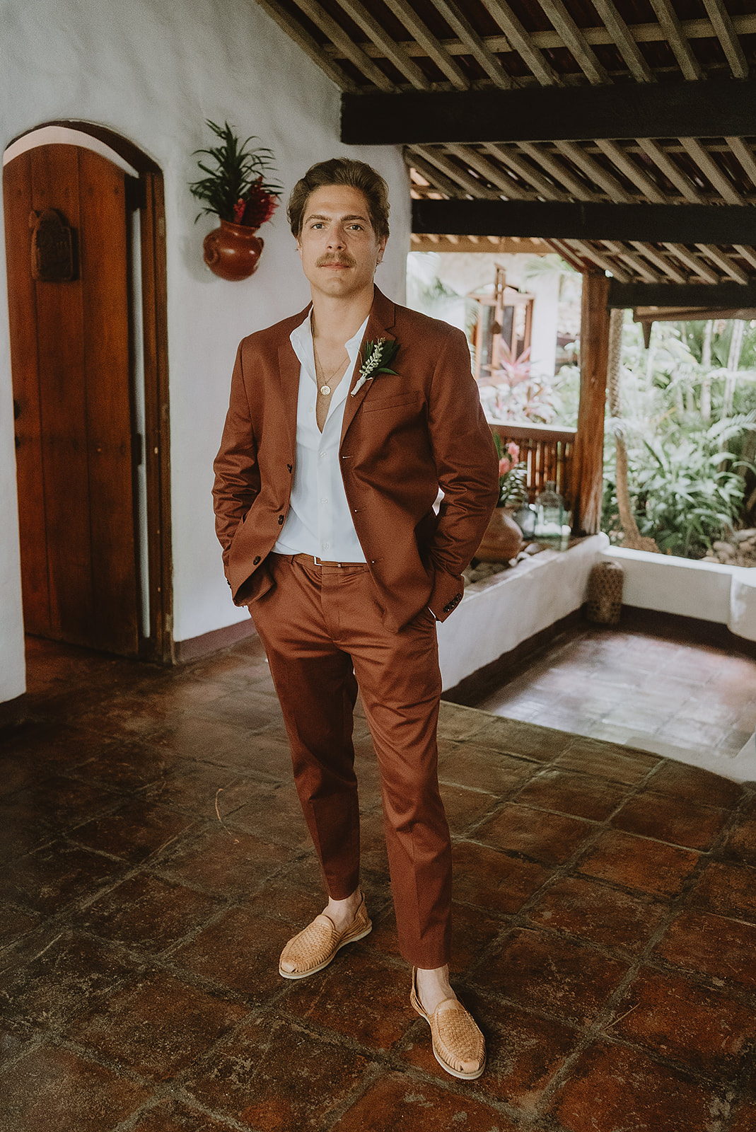 rust colored suit and shoes groom