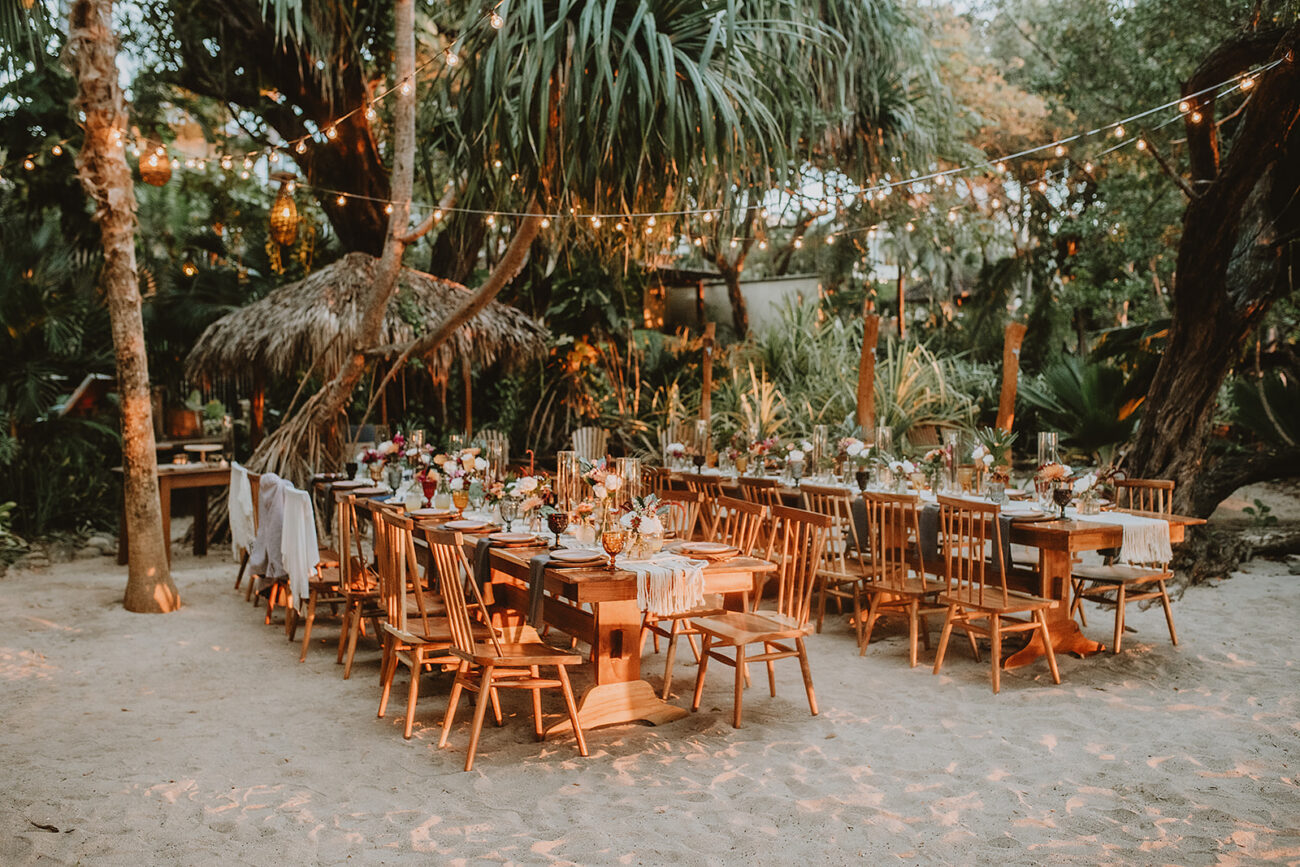 costa rica A beach wedding reception set up in the sand under a palm tree captured by a talented Costa Rica photographer.