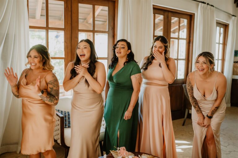 costa rica A group of bridesmaids laughing in a room, captured beautifully by a talented Costa Rica photographer.