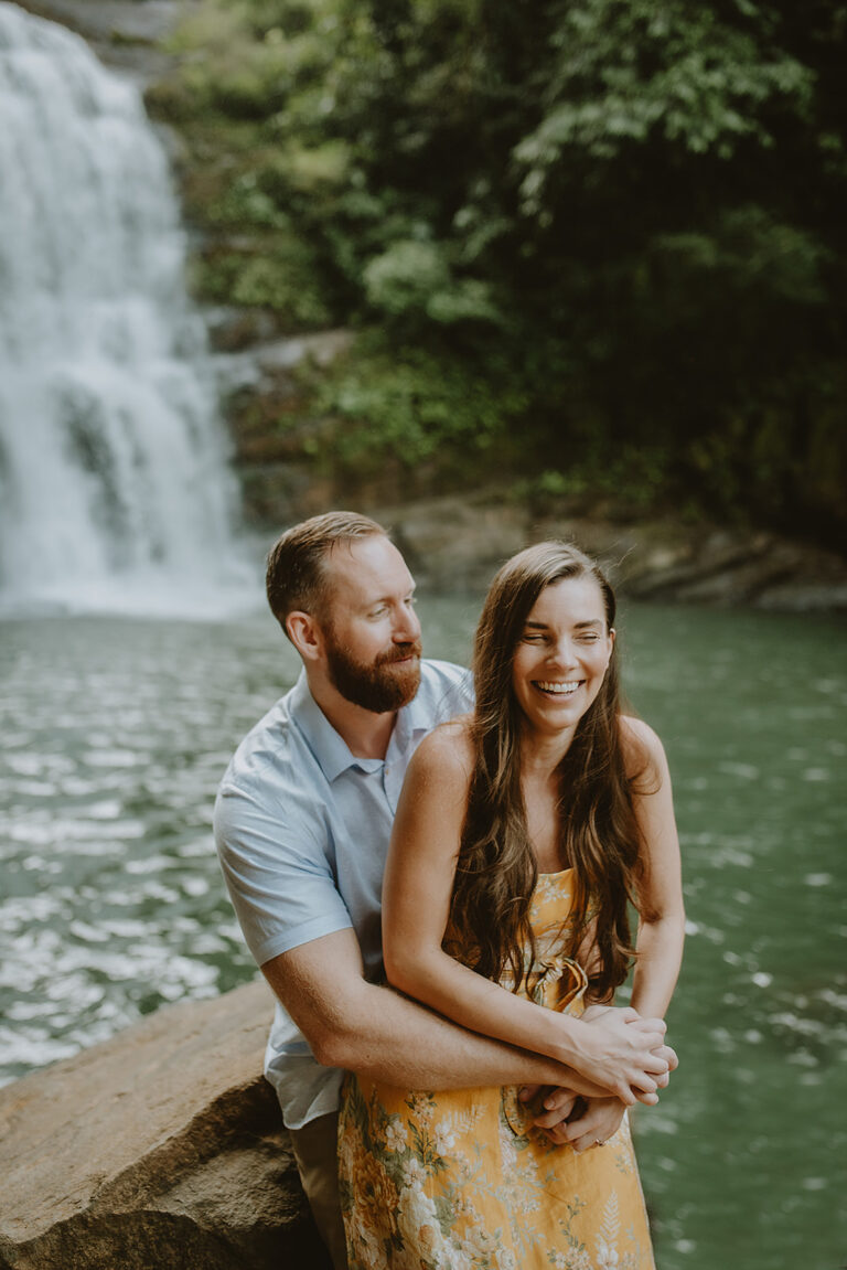 costa rica An engaged couple posing in front of a waterfall during their Costa Rica wedding, captured by a talented photographer.