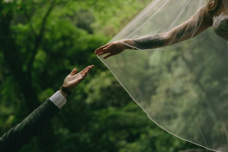 Best Documentary Wedding Photographers In Costa Rica | Adri and Lucas 19 A hand lifting the bride's veil against Costa Rica rainforest green