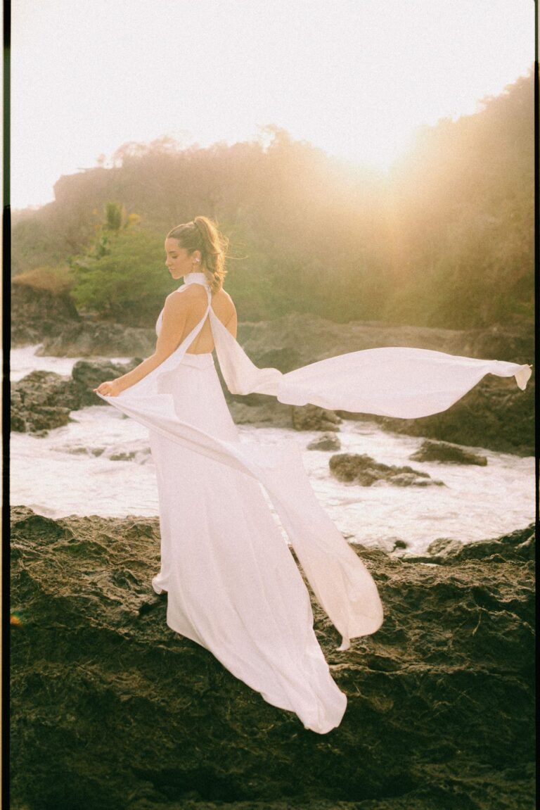 Best Documentary Wedding Photographers In Costa Rica | Adri and Lucas 9 Bride's dress catching the wind on the Montezuma coast at golden hour, Costa Rica