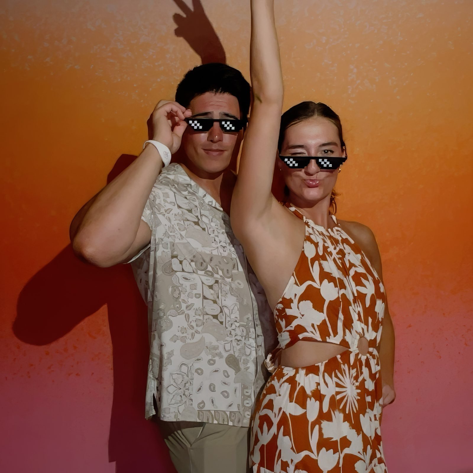 Couple posing with pixel glasses