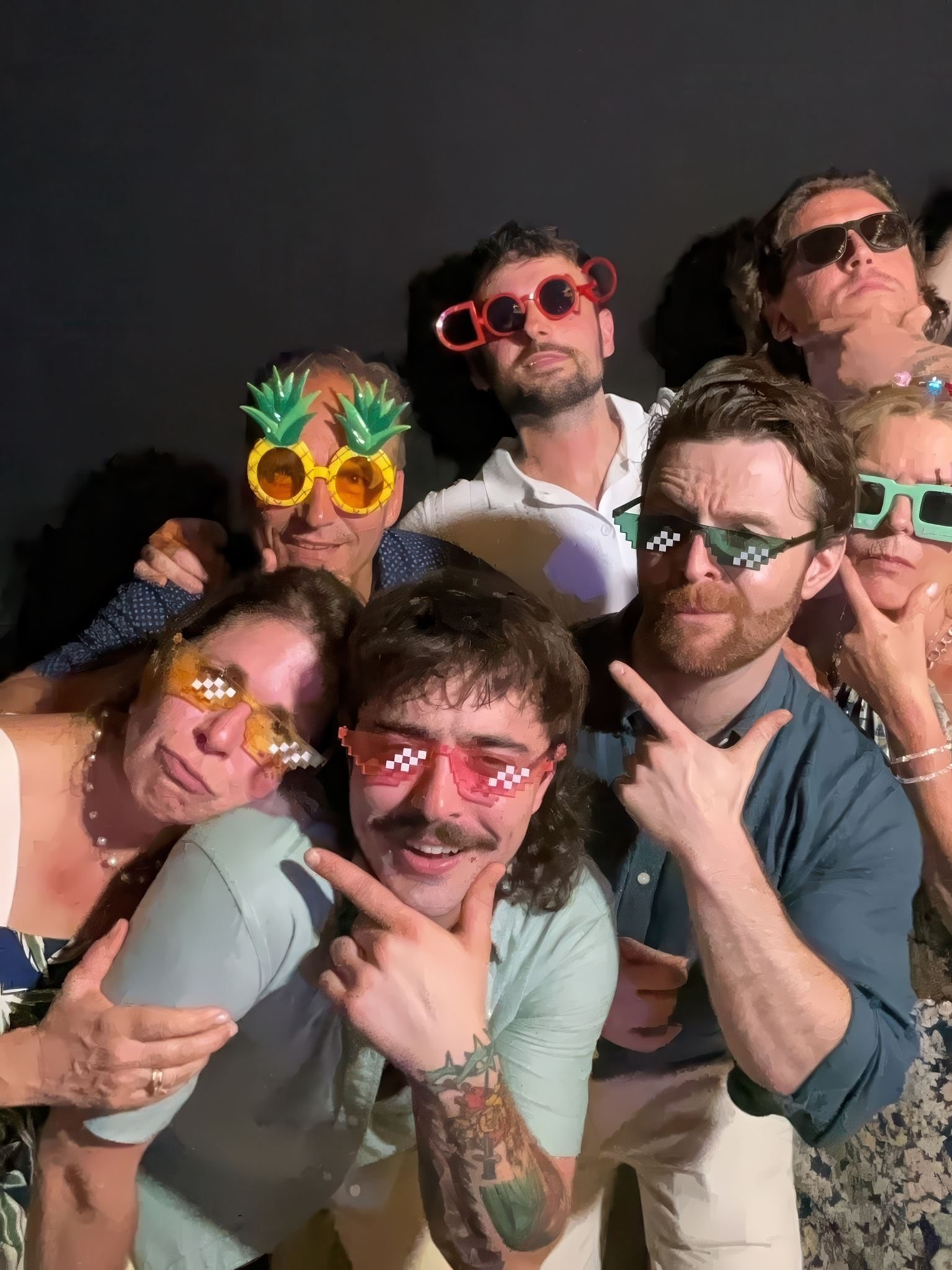 Guests in party glasses at the photobooth