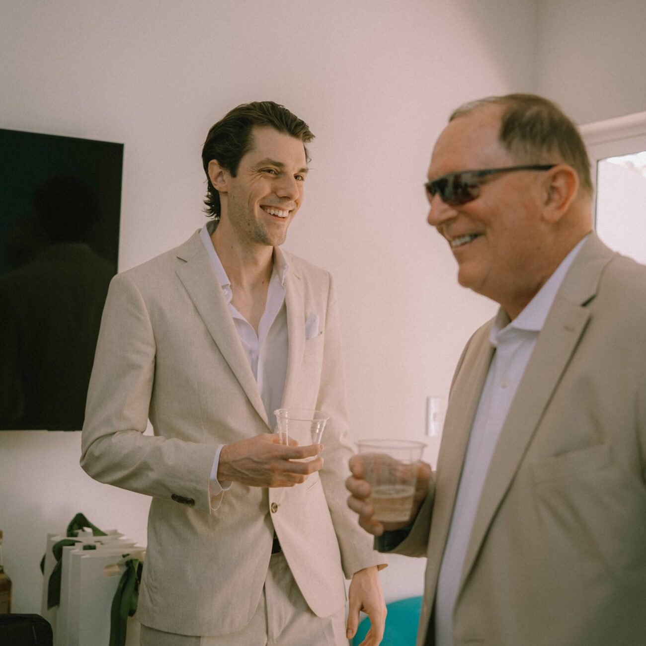 The groom laughing with a guest before the ceremony