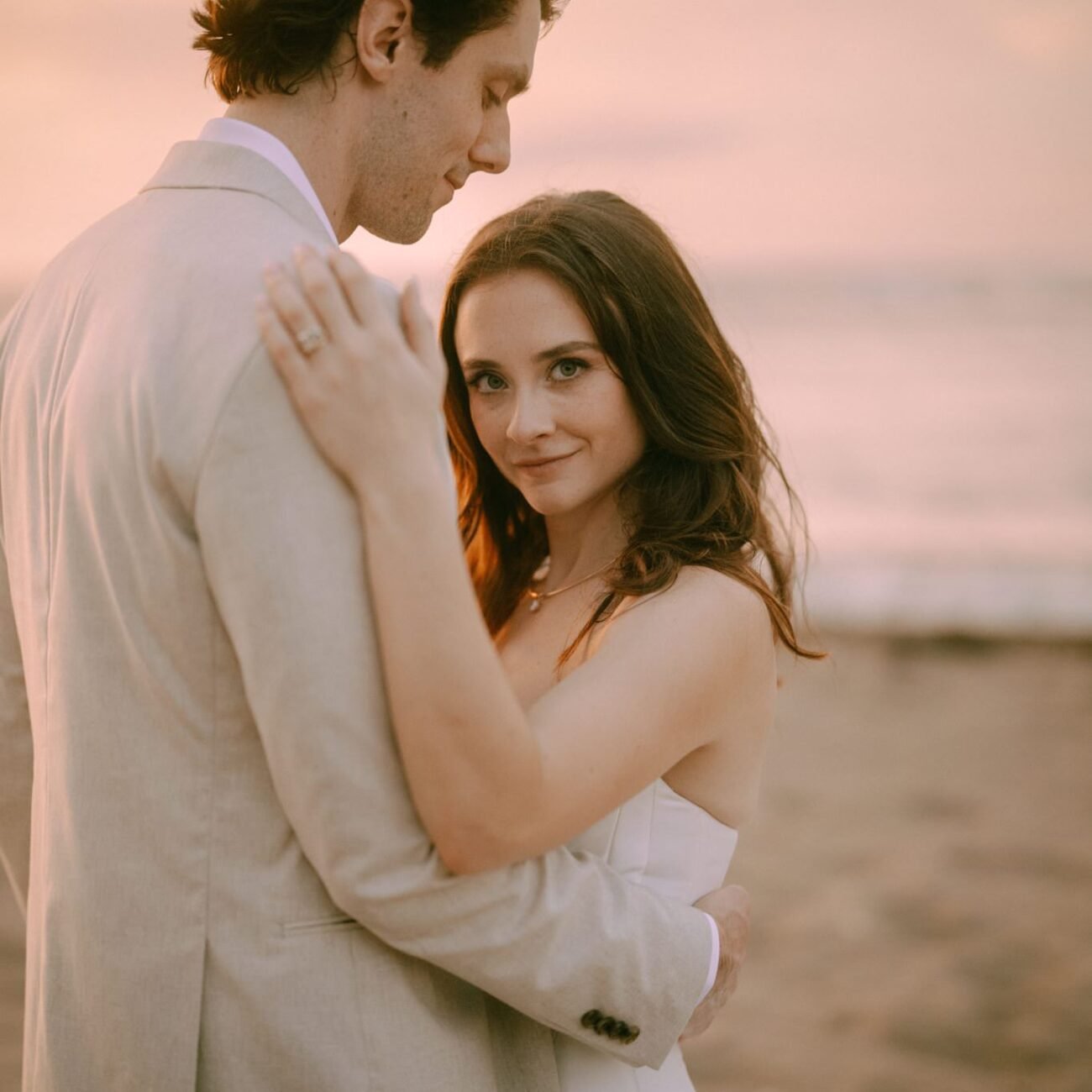 The couple embracing on the sand at sunset in Tamarindo